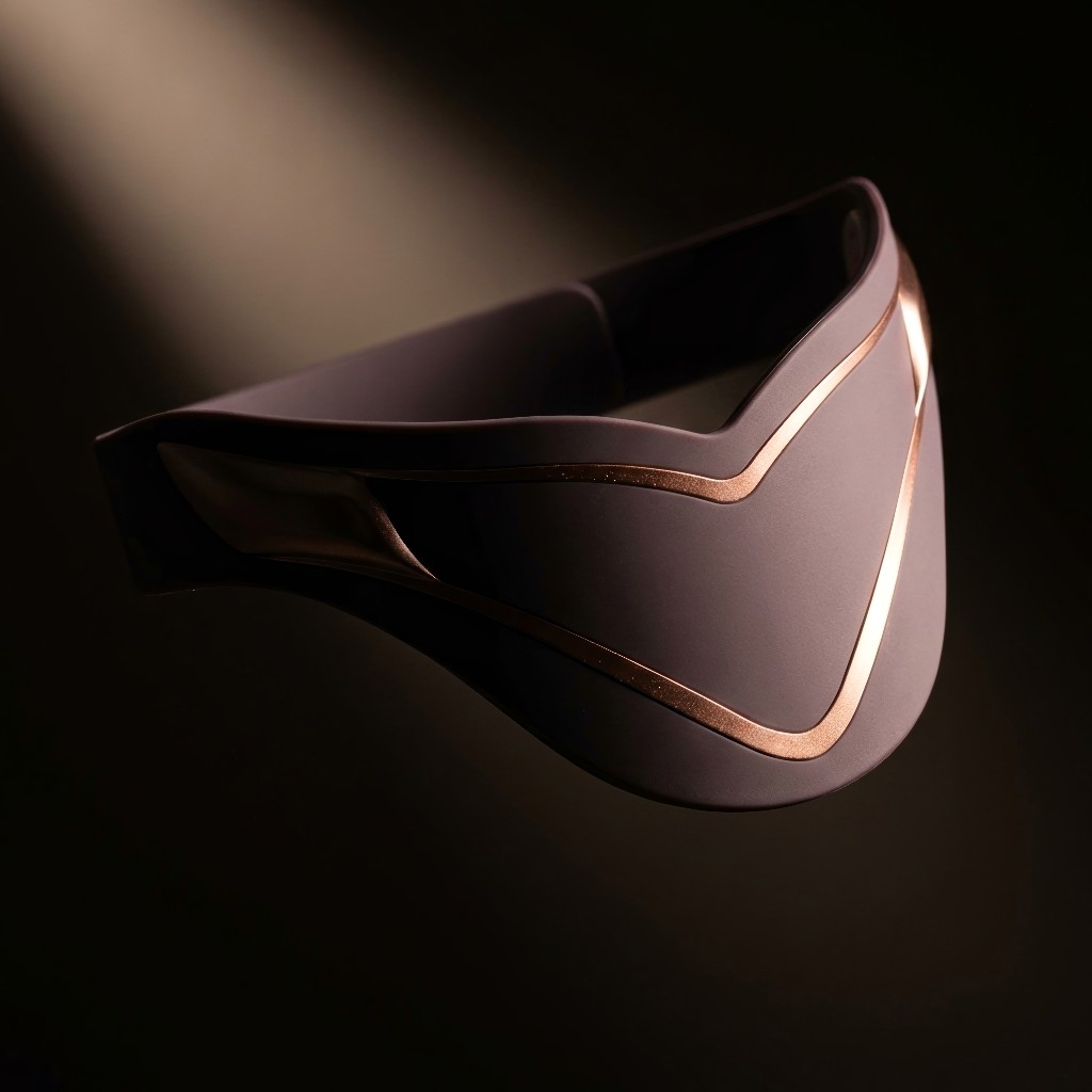 MinaRosa belt in dramatic studio spotlight, back angle catching warm rose gold highlights